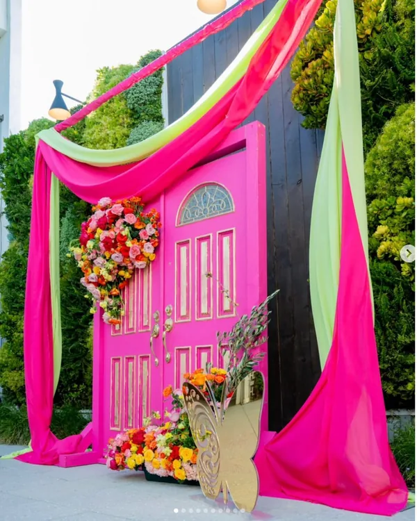 Custom hot pink fabricated doorway entrance with floral installation