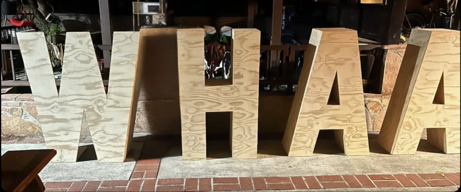 Close-up of large plywood WHAA letters fabricated for the festival stage